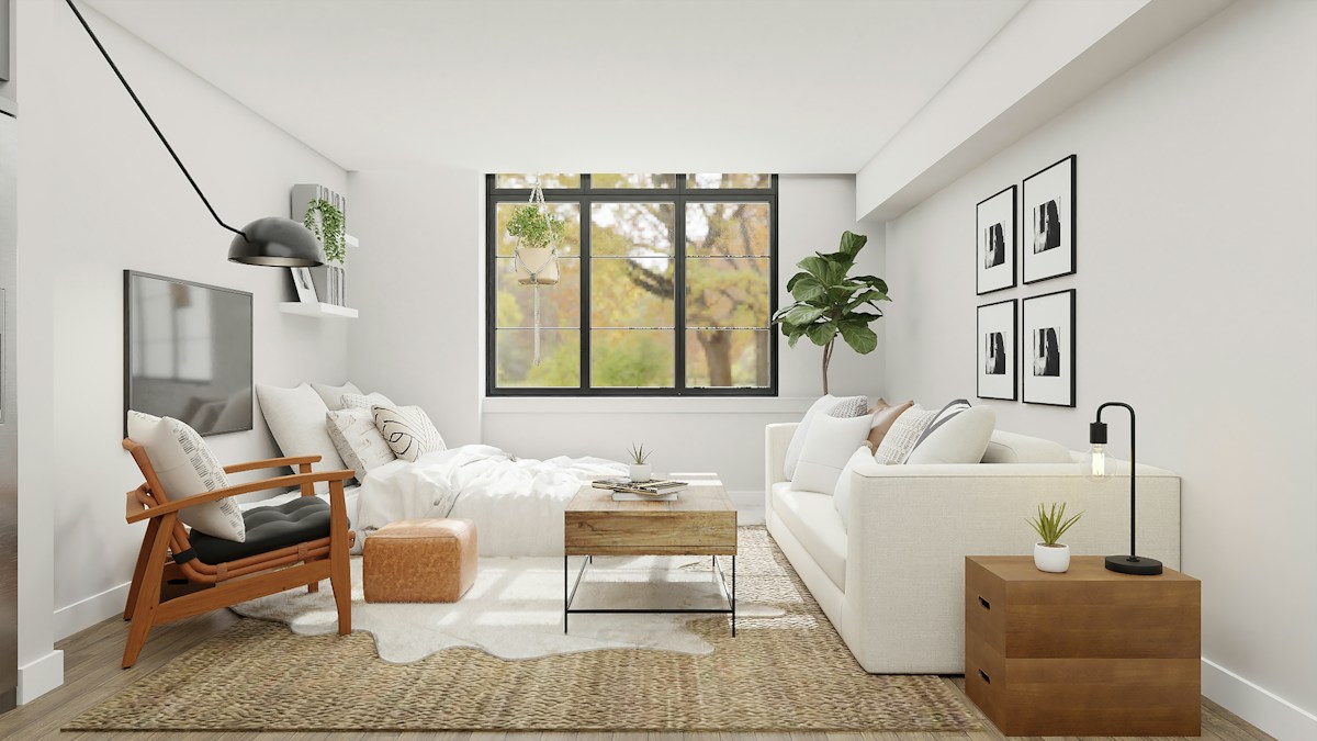 Không gian phòng khách với sofa sáng màu và cửa sổ lớn